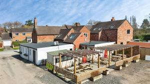 a building being constructed in front of a house at The Winners Enclosure - Country Flat Above a Village Pub in Shrewsbury