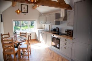 a kitchen with a table and a dining room at The Winners Enclosure - Country Flat Above a Village Pub in Shrewsbury