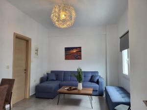 a living room with a blue couch and a table at Castle View #3-4 in Kavála