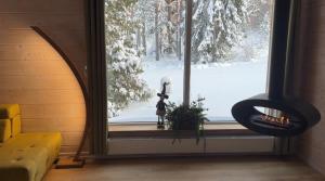 a window with a view of a snow covered yard at ForrestVila in Karačiūnai +12 photos