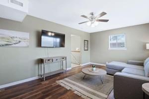a living room with a couch and a flat screen tv at Quiet Getaway, Travis' Place! Affordable Location in Rossville