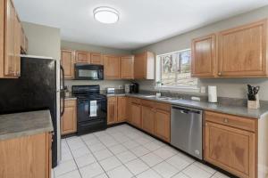 a kitchen with wooden cabinets and stainless steel appliances at Quiet Getaway, Travis' Place! Affordable Location in Rossville