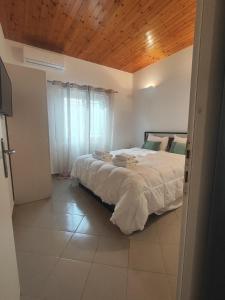 a bedroom with a large bed with a wooden ceiling at Piazza di Lefkimmi in Lefkimmi