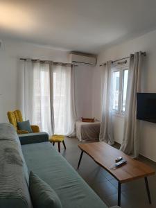 a living room with a couch and a coffee table at Piazza di Lefkimmi in Lefkimmi