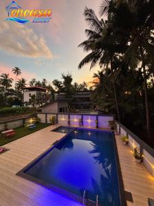 a swimming pool in the backyard of a house at Encasa Resort in Nagaon