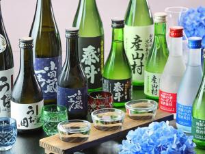 a group of wine bottles and glasses on a table at Gogaku Hotel in Aso