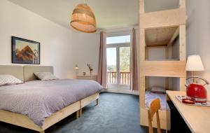 a bedroom with a bunk bed and a balcony at Chambres de charme avec piscine - Le Monde de Charlie - Proche Vichy in Vichy +69 photos