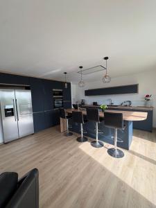 a kitchen with a table and chairs in a room at La Claverie in Cholet