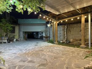 a patio with a garage with lights on it at KEYDEO House in Phan Thiet