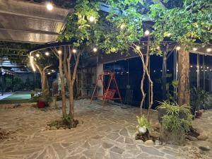 a greenhouse with trees and lights in a building at KEYDEO House in Phan Thiet +20 photos