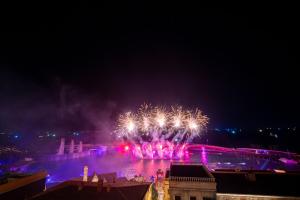 a fire show with fireworks in the water at night at HUB MULTI 3 HOTEL - Sea & Firework View in Phú Quốc