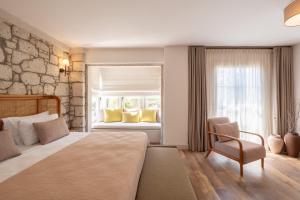 a bedroom with a bed and a window at Fiora Alacati in Alaçatı +46 photos
