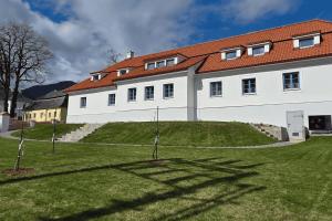 a large white building with a red roof at Penzión Jánsky kaštieľ Bohumírovský in Liptovský Ján