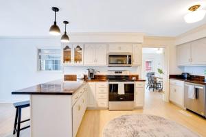 a kitchen with white cabinets and a black counter top at Countryside Retreat with Views! Red Clay Farmhouse in Cleveland