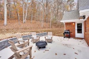a patio with chairs and a fire pit next to a house at Countryside Retreat with Views! Red Clay Farmhouse in Cleveland