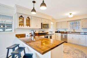 a kitchen with white cabinets and a wooden counter top at Countryside Retreat with Views! Red Clay Farmhouse in Cleveland