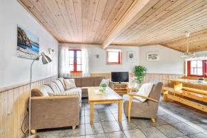 a living room with a couch and a table and a piano at Skottevik Feriesenter in Skottevik