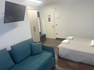 a living room with a couch and a bed at B&B Caricone in Orta Nova