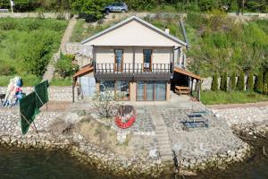an aerial view of a house with a boat in the water at Kuca za odmor Labud in Donji Milanovac
