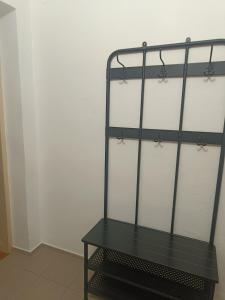 a black shelf in a room next to a wall at Apartmán Procyon in Prostějov +1 photo