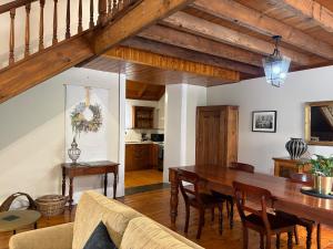 a kitchen and dining room with a wooden table at Roscrow Heritage Retreat in Clare