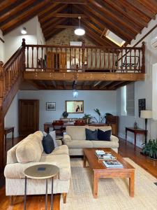 a living room with a couch and a table at Roscrow Heritage Retreat in Clare