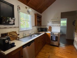 a kitchen with a sink and a stove at Roscrow Heritage Retreat in Clare
