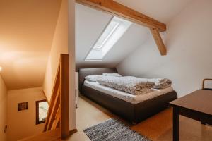 a bedroom with a bed in a attic at Grillnhäusl - Ruheoase in Alleinlage mit Sauna, Erlebnisstadl & Rehen vor der Haustür in Wegscheid