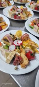 a bunch of plates of food on a table at Pensiunea Moldova in Piatra Neamţ