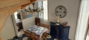 a dining room with a clock on the wall at CASA LUIGIA ROOMS MTB in FINALBORGO Bike room in Finale Ligure