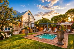 a backyard with a swimming pool and a house at The Villa Manor & Spa Exclusive Escape in Bela-Bela