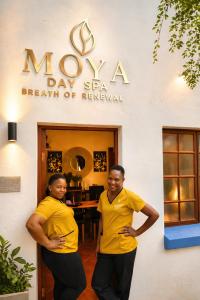 two men in yellow shirts standing in front of a salon at The Villa Manor & Spa Exclusive Escape in Bela-Bela +82 photos