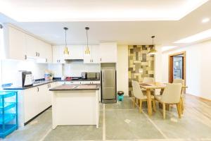 a kitchen and dining room with a table and chairs at Mandala Living Kathmandu in Kathmandu