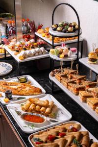 a buffet filled with different types of food on trays at Marhaba Hotel & Spa in Tashkent