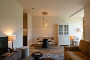 a living room with a couch and a table at Corneli Residences - Château St Gerlach in Valkenburg