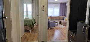 an open door to a living room with a couch at Opal Skay Apartment in Doboj