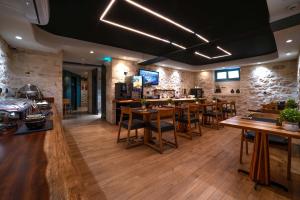 a restaurant with wooden tables and chairs and a bar at Artion City Boutique Hotel in Heraklio +27 photos