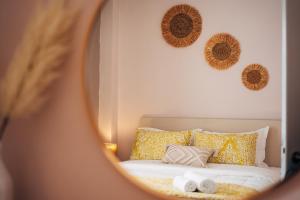 a woman is looking at a bed in a mirror at Aether View Premium Views in Central Mytilene in Mytilene