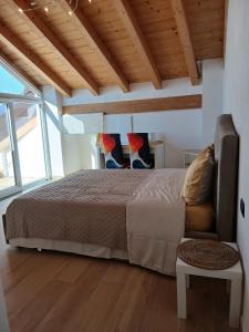 a bedroom with a bed in a room with wooden ceilings at Casa Carlotta in Perledo