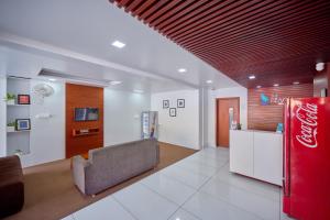 a living room with a coca cola refrigerator at The Reach Hotel in Cochin