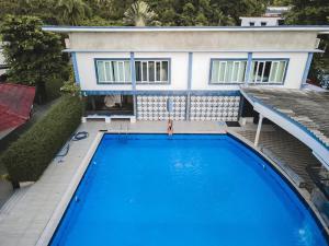 a swimming pool in front of a house at Barn Talaepu Resort in Ban Suan Khat