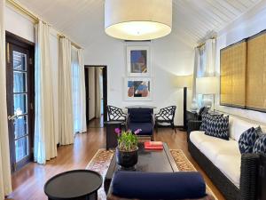 a living room with a couch and a table at Rachamankha Hotel in Chiang Mai