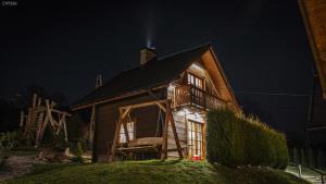 a house at night with a light on the roof at Jaworowa Osada in Brenna