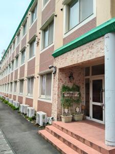 a building with stairs leading to the front door at Guest House Bamboo in Morioka