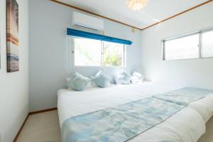 a large bed in a room with a window at AQUAMARINE HOTEL Nagahama in Nagahama