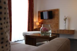 a hotel room with a vase with a flower on a table at Der Wieshof in Riedlhütte