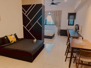 a room with a bed and a table and a dining room at Chamber Haven KL in Kuala Lumpur