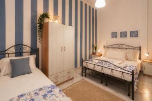 a bedroom with two beds and a cabinet in it at Poésia in San Foca