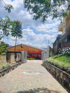 a walkway with graffiti on the side of a building at Kalpho Art Center Guesthouse- near Embassy District in Kigali