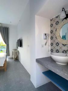 a bathroom with a sink and a mirror on the wall at Laco Villa in Danang +11 photos